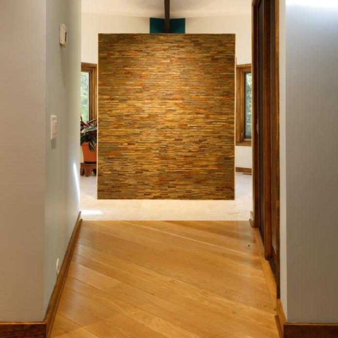 - Stacked stone wall with shower on opposite side.